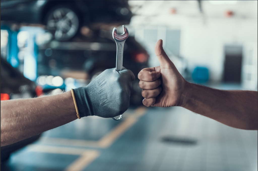 Two mechanics working on a car near Coeur d;Alene Honda.