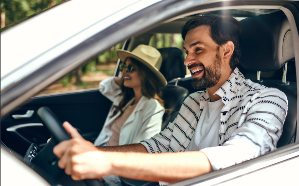 A man and a woman laughing with the window rolled down on a 2024 Honda Ridgeline near Coeur d'Alene, ID.