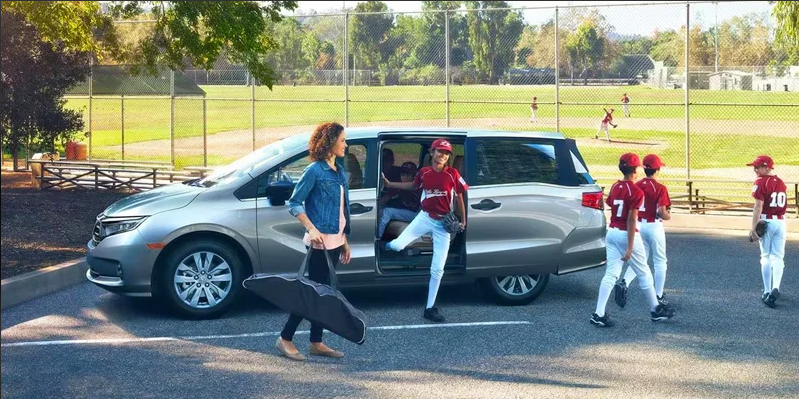 A group of little league aged kids getting out of the 2024 Honda Odyssey near Coeur d'Alene Honda.