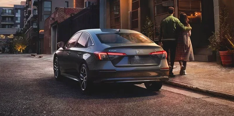 A 2024 Honda Civic Hatchback parked on the side of the road.