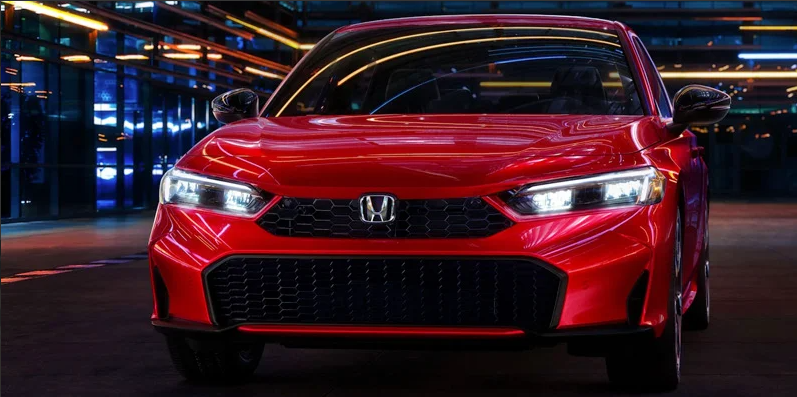 A red 2025 Honda Civic driving down the road.