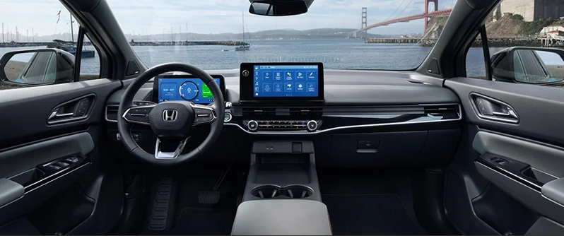 The dashboard of a 2025 Honda Prologue with the sea and a bridge visible through the front windshield.