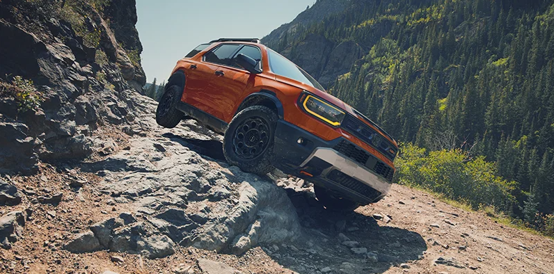 An orange 2026 Honda Passport offroading.