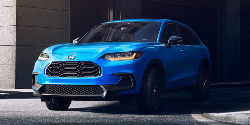 A sleek blue Honda SUV parked on a city street, showcasing its modern design.