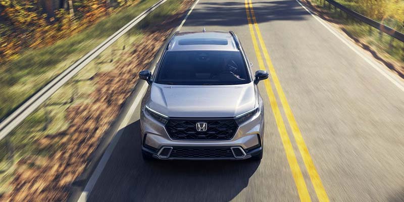 New Silver 2026 Honda CR-V Cruising on plain road