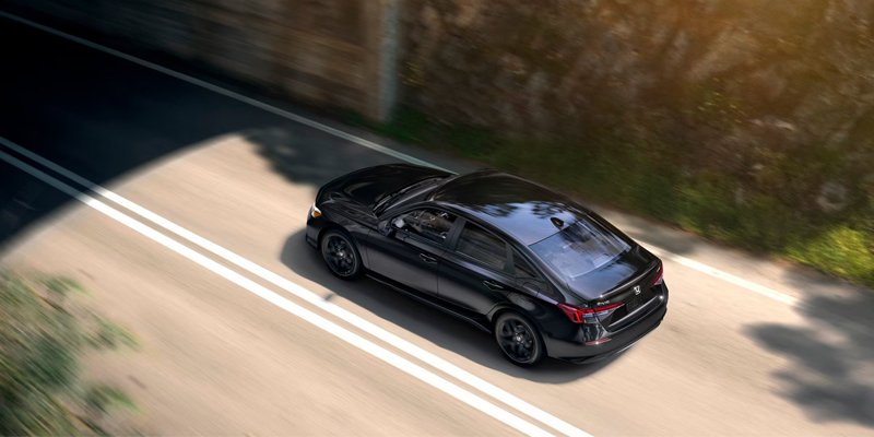 2026 Black Honda Civic Sedan Sport cruising on road
