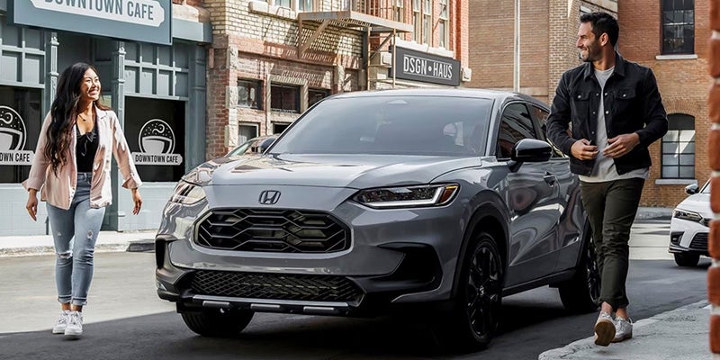 A couple walks away from a parked 2024 Honda HR-V